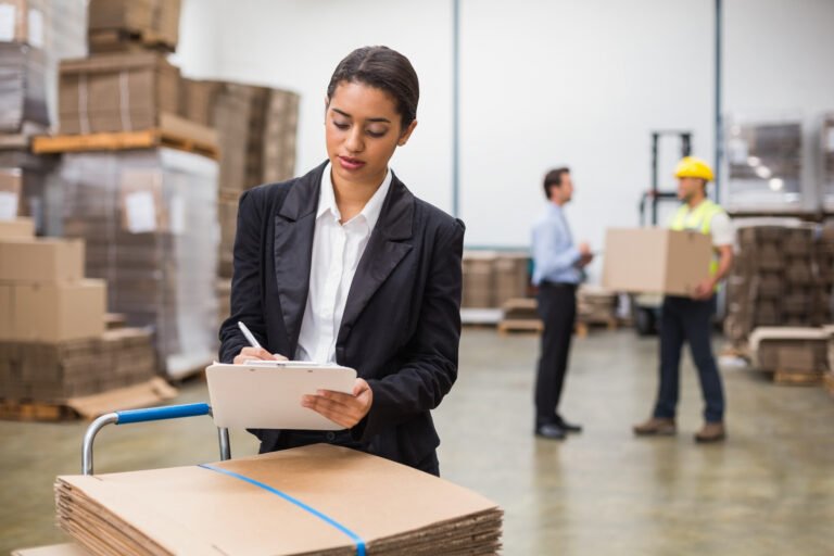 pretty warehouse manager writing clipboard